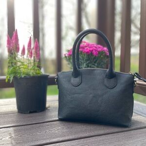Bueno black leather handbag with strap (like- new and in excellent condition).